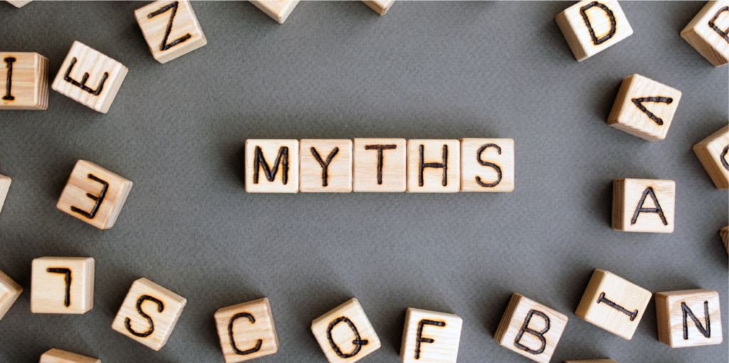 Letter tiles spelling the word myths with other letters scattered