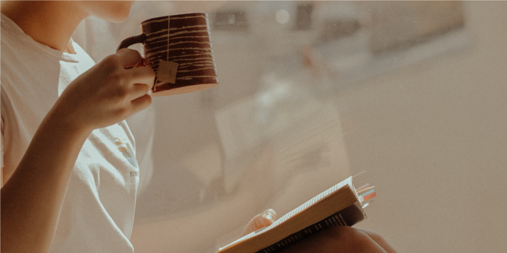 Woman resting with a book and coffee